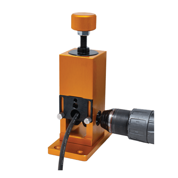 Rack-A-Tier Wire Peeler wire stripping machine in bronze color. A drill is attached to the side and a wire is fed into the front.