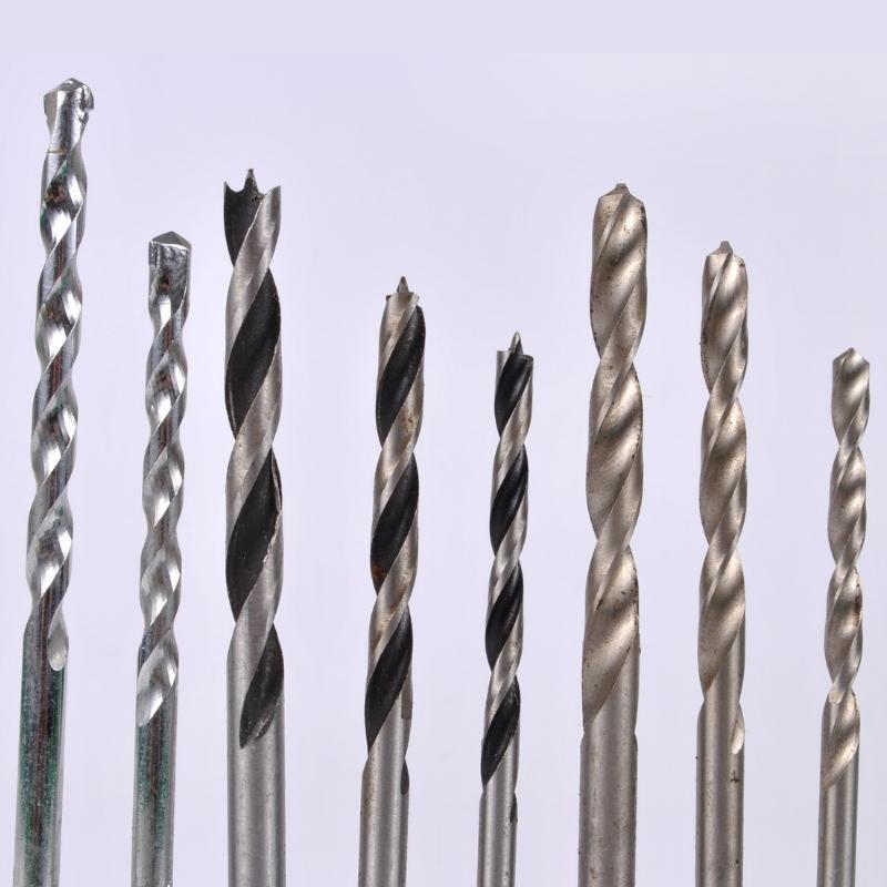 several auger-style drill bits lined up on a blue background.